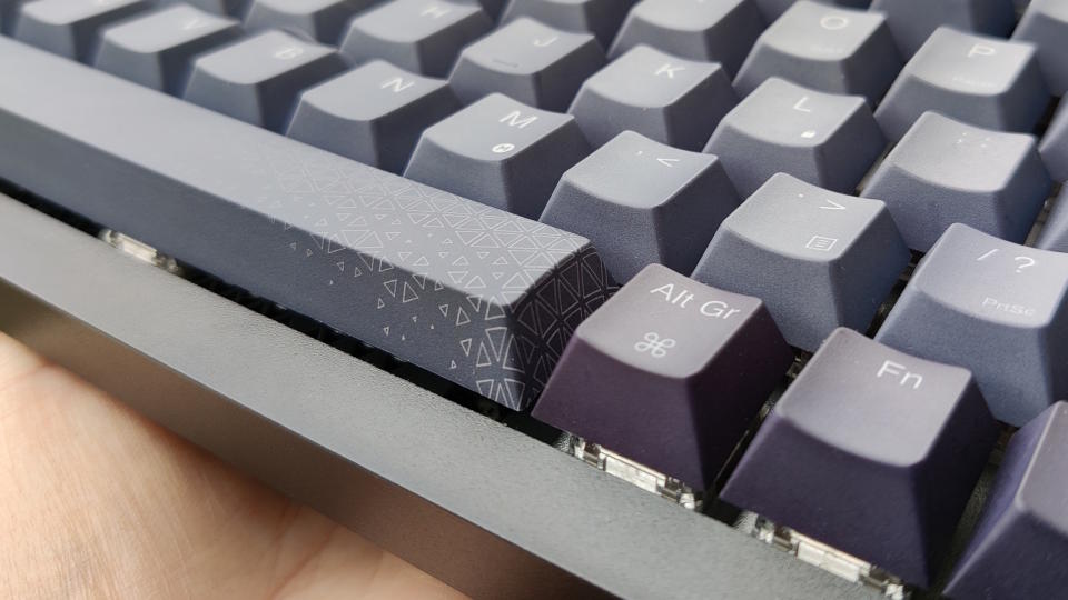 Corsair K65 pictured outdoors with black and grey keycaps.