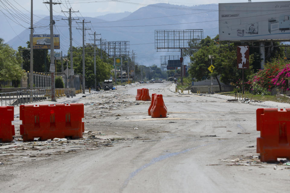 A street alongside the U.S. embassy compound is devoid of traffic in Port-au-Prince, Haiti, Sunday, March 10, 2024. The U.S. military said Sunday that it had flown in forces to bolster security at the delegation and facilitate the departure of nonessential personnel. (AP Photo/Odelyn Joseph)