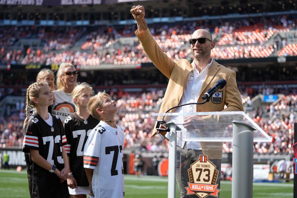 Former Cleveland Browns player Joe Thomas acknowledges the crowd after being inducted into the football team's Ring of Honor and receiving his Pro Football Hall of Fame ring of excellence during halftime of an NFL football game against the Baltimore Ravens, Sunday, Oct. 1, 2023, in Cleveland. (AP Photo/Sue Ogrocki)