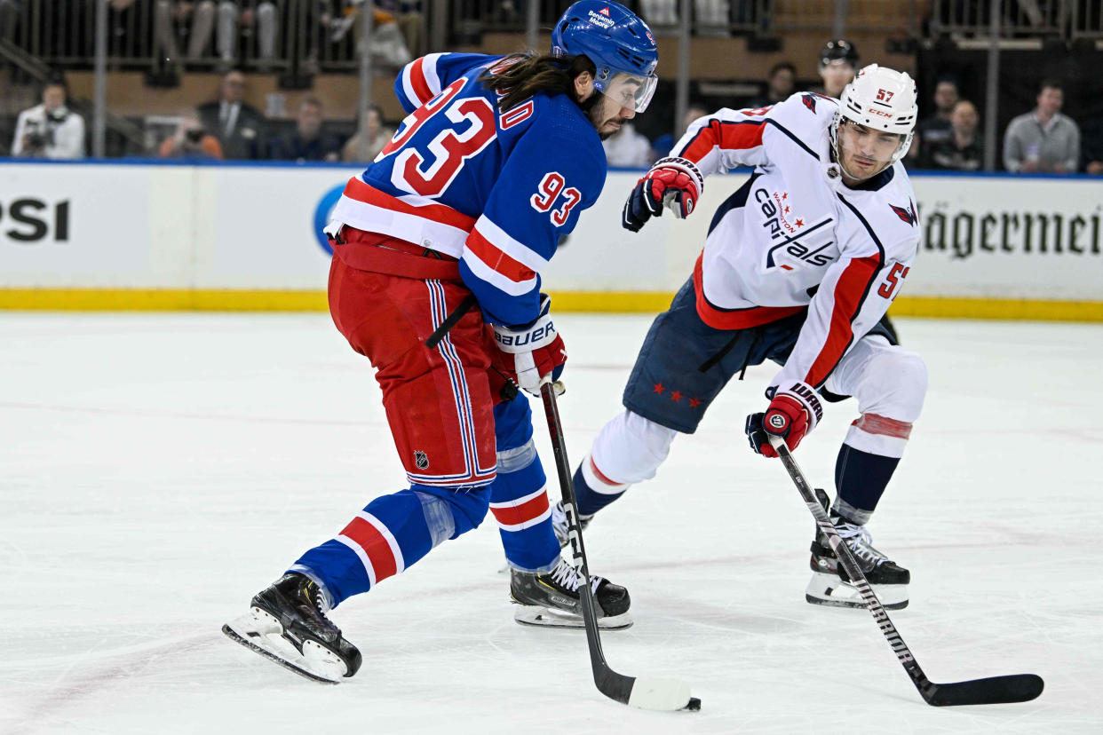 Apr 23, 2024; New York, New York, USA; New York Rangers center Mika Zibanejad (93) attempts a shot defended by Washington Capitals defenseman Trevor van Riemsdyk (57) during the first period in game two of the first round of the 2024 Stanley Cup Playoffs at Madison Square Garden.
