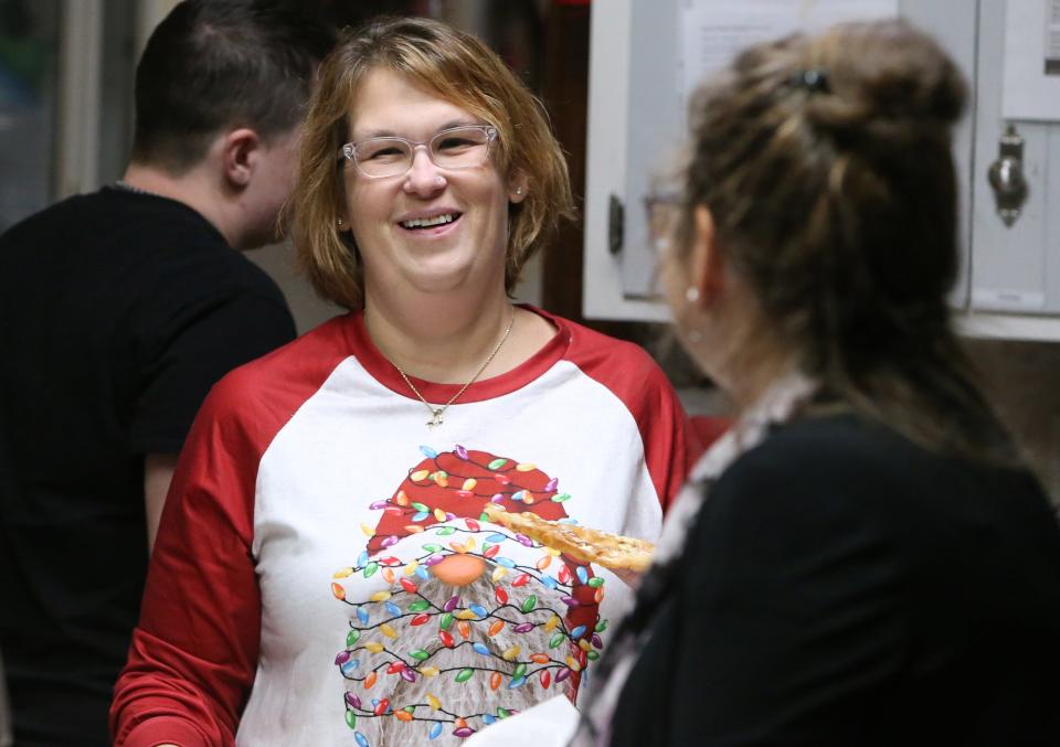 Executive Director Maria Stancati smiles after talking with residents and staff in the kitchen Wednesday, Dec. 20, 2023, at Dismas House in South Bend.