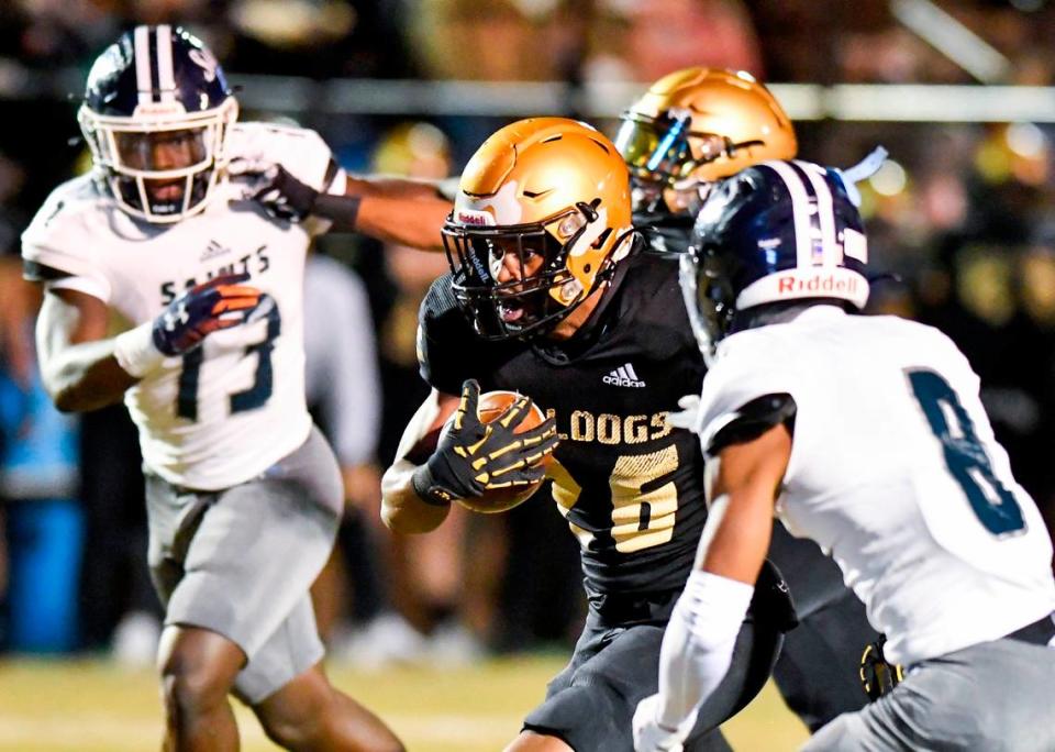 Mary Persons running back Duke Watson (26) runs for a first down during the Bulldogs’ home playoff game Friday night against Cedar Grove.