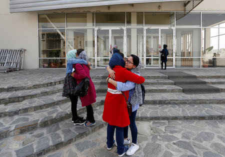 Female students of American University of Afghanistan hug each other as they arrive for new orientation sessions at a American University in Kabul. REUTERS/Mohammad Ismail