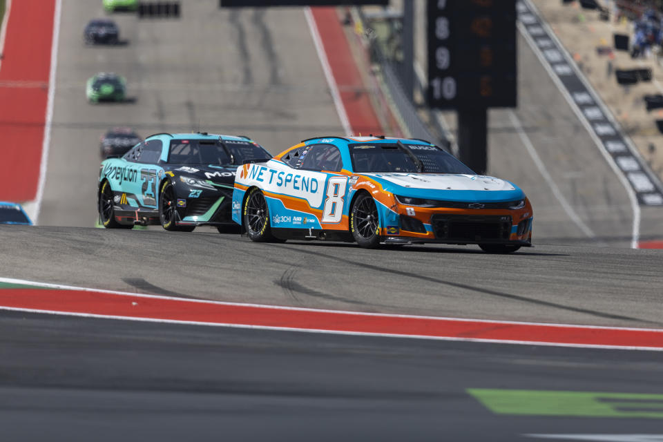 Bubba Wallace (23) and Kyle Busch (8) steer out of Turn 1 during a NASCAR Cup Series auto race at Circuit of the Americas, Sunday, March 26, 2023, in Austin, Texas. (AP Photo/Stephen Spillman)
