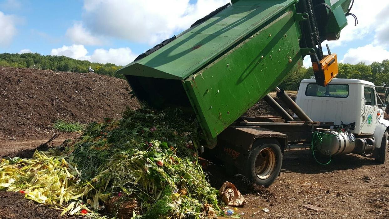 Food waste collected as part of a program operated by Emmet County is emptied from a truck in an earlier year.