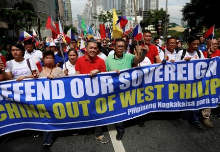 FILE PHOTO: Filipino activists and opposition leaders march to protest at the Chinese Embassy in Makati City