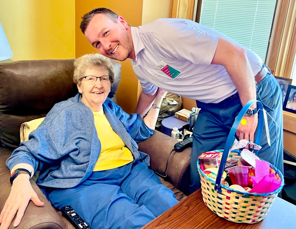 PLH Eden Acres Campus resident Margaret “Kay” Bates poses with volunteer Cole Adair after receiving her Project Deliver the Love delivery in 2023.