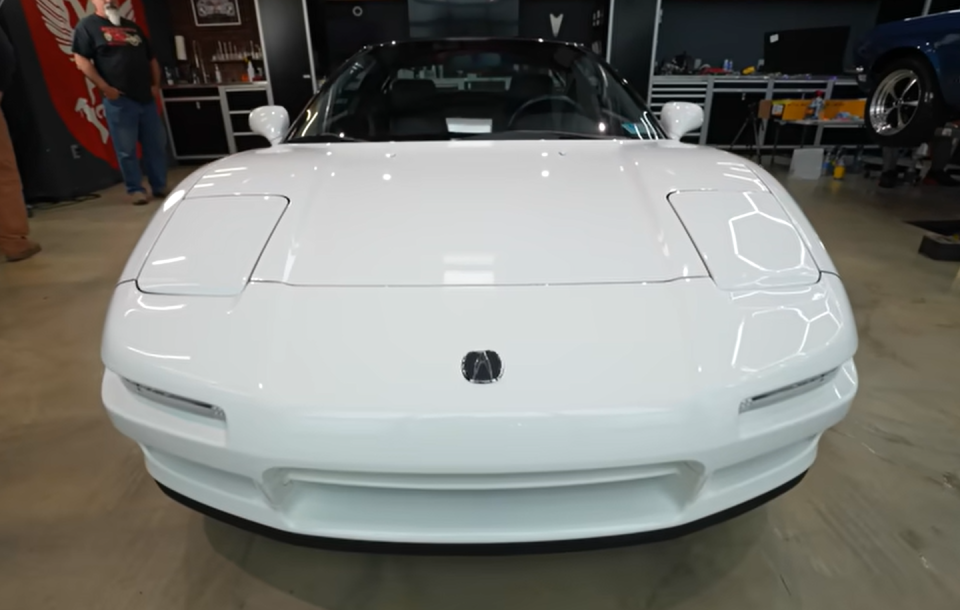 a white car parked in a showroom