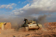 Popular Mobilisation Forces (PMF) fighters ride in a tank near the Iraqi-Syrian border in al-Qaim, Iraq. Iraq November 26, 2018. REUTERS/Alaa al-Marjani