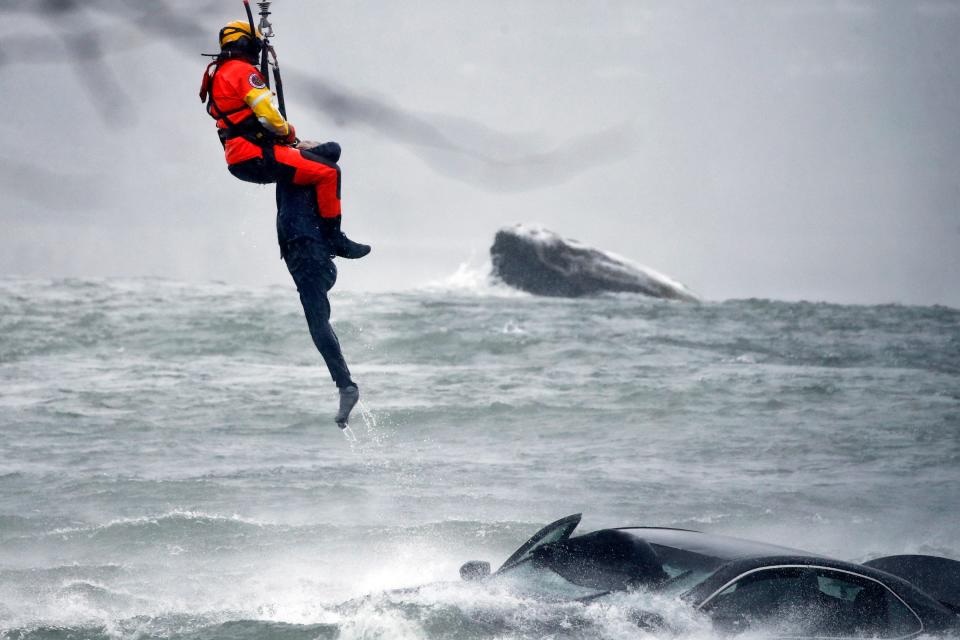 coast guard rescuer pulls woman from submerged car