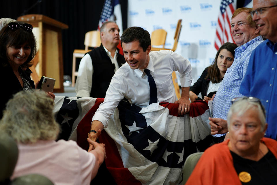 Pete Buttigieg, South Bend Mayor and Democratic presidential hopeful, shakes hands with an attendee in a wheelchair following a campaign event at Saint Ambrose University in Davenport, Iowa, U.S. September 24, 2019.   REUTERS/Elijah Nouvelage