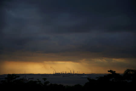 FILE PHOTO: Storm clouds gather over Shell's Pulau Bukom oil refinery in Singapore January 30, 2016. REUTERS/Edgar Su/File Photo