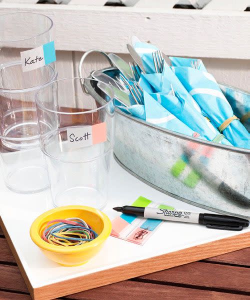 <p>Put home-office supplies to work: Plastic stick-on flags make perfect drink labels and rubber bands will secure napkin-wrapped cutlery, so partygoers can grab flatware one-handed. </p>