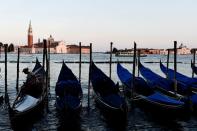 FILE PHOTO: A Gondolier is seen in front of San Giorgio Maggiore island amid the coronavirus disease (COVID-19) outbreak in Venice