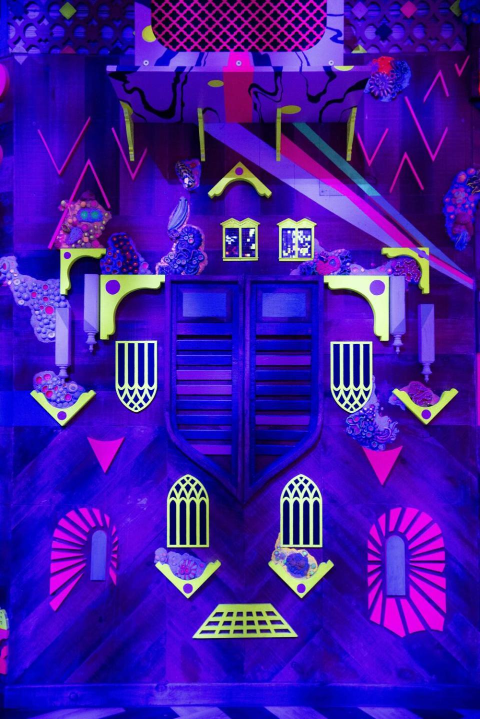 An area of Meow Wolf's Grapevine, Texas, exhibit is fashioned as a neon city.