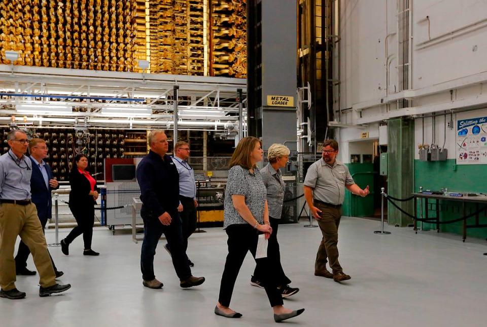 Energy Secretary Jennifer Granholm, second from right, is shown the historic B Reactor by Colleen French of the Department of Energy and Patrick Jaynes, B Reactor operations manager, Friday.