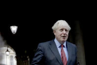 British Prime Minister Boris Johnson walks back into Downing Street after attending a cabinet meeting at the Foreign and Commonwealth Office in London, Tuesday, Sept. 22, 2020. Johnson plans to announce new restrictions on social interactions Tuesday as the government tries to slow the spread of COVID-19 before it spirals out of control. (AP Photo/Matt Dunham)