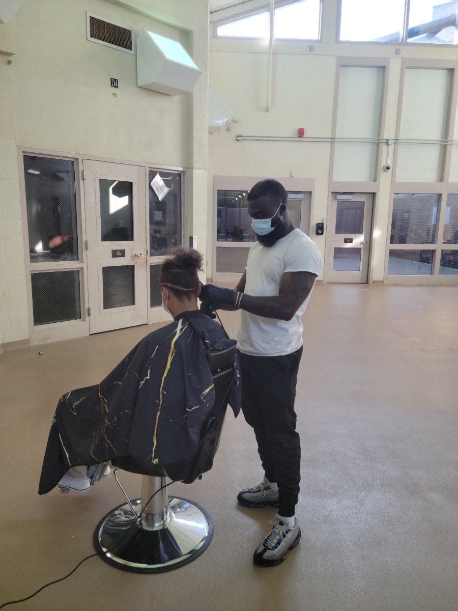 Barber Isaac Zepu provides a haircut for Oklahoma County's Juvenile Bureau. The Hair Initiative donated two barber chairs and helped contract a barber and hairstylist to visit every Monday and provide services.