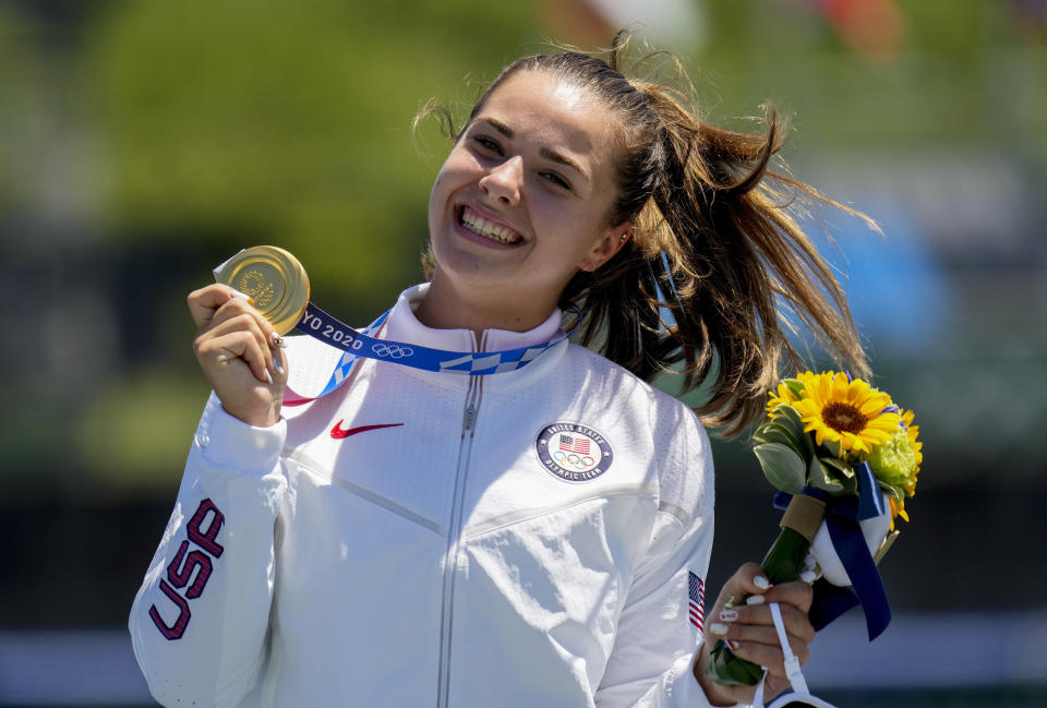 Nevin Harrison, of the United States, holds her up gold medal after winning the women's canoe single 200m final at the 2020 Summer Olympics, Thursday, Aug. 5, 2021, in Tokyo, Japan. (AP Photo/Lee Jin-man)