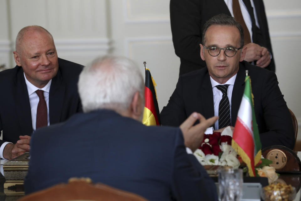 German Foreign Minister Heiko Maas, right, attends a meeting with his Iranian counterpart Mohammad Javad Zarif, back to camera, in Tehran, Iran, Monday, June 10, 2019. German ambassador to Tehran Michael Klor-Berchtold sits at left. (AP Photo/Ebrahim Noroozi)