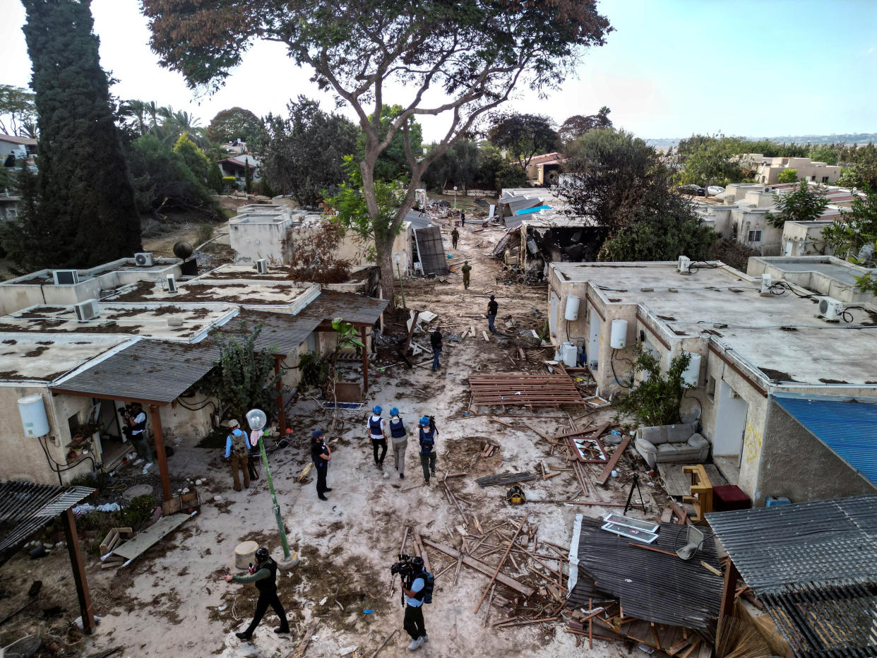 An aerial view shows members of the media during a visit to Kibbutz Kfar Aza, in the aftermath of a deadly attack by Hamas gunmen from the Gaza Strip, in southern Israel, October 15, 2023. REUTERS/Ilan Rosenberg