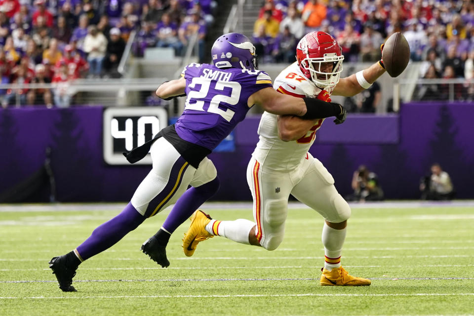 Kansas City Chiefs tight end Travis Kelce (87) runs from Minnesota Vikings safety Harrison Smith (22) after catching a pass during the first half of an NFL football game, Sunday, Oct. 8, 2023, in Minneapolis. (AP Photo/Abbie Parr)