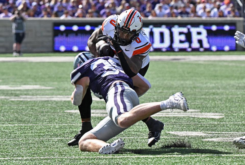 MANHATTAN, KS - SEPTEMBER 28: Defensive end Brendan Mott #38 of the Kansas State Wildcats tackles running back Ollie Gordon II #0 of the Oklahoma State Cowboys in the first half at Bill Snyder Family Football Stadium on September 28, 2024 in Manhattan, Kansas. (Photo by Peter Aiken/Getty Images)