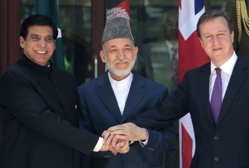 Britain's Prime Minister David Cameron (R), Pakistani Prime Minister Raja Pervez Ashfraf (L), and Afghan President Hamid Karzai shake hands before a meeting at the presidential palace in Kabul. Afghan efforts to negotiate with the Taliban need Islamabad's help if they are to be successful, the leaders of Afghanistan, Britain and Pakistan emphasised