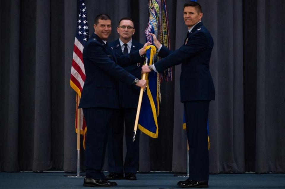 Col. Scott P. Weyermuller, right, incoming 2nd Bomb Wing commander, receives the guidon from Maj. Gen. Andrew J. Gebara, left, 8th Air Force and Joint-Global Strike Operations Center commander, during a change-of-command ceremony at Barksdale Air Force Base, Louisiana, March 31, 2022. Weyermuller is the 65th commander to lead the base since Barksdale first opened its gates in 1933.