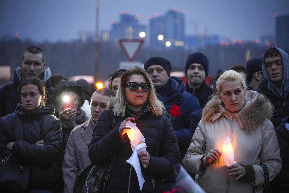 FILE - People react next to the Crocus City Hall, on the western edge of Moscow, Russia, Saturday, March 23, 2024. Twenty-two victims of the Russia concert hall attack that killed more than 130 people remain in serious condition in the hospital, Health Minister Mikhail Murashko said Tuesday, March 26, 2024, according to state news agency Tass. Two of them are children, it said. (AP Photo/Alexander Zemlianichenko, File)