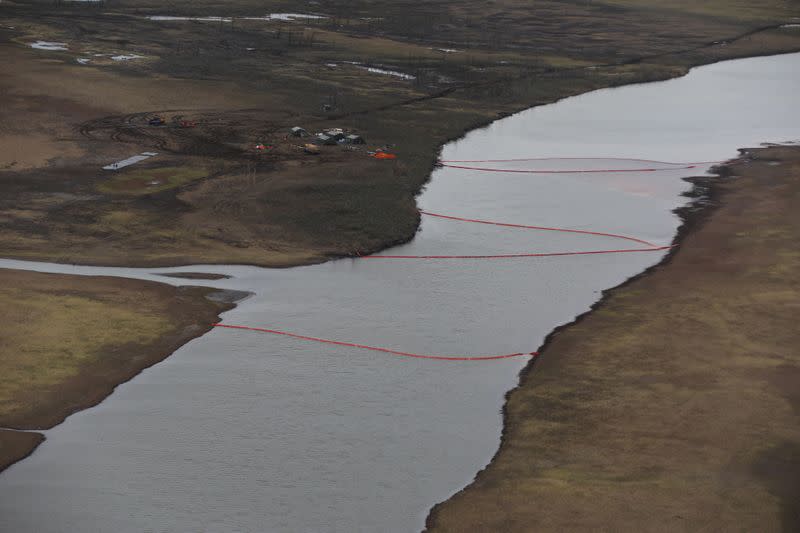 An aerial view shows a camp of rescuers and containment booms installed at the site of a huge leak of diesel fuel into the river after an accident at a power plant outside Norilsk