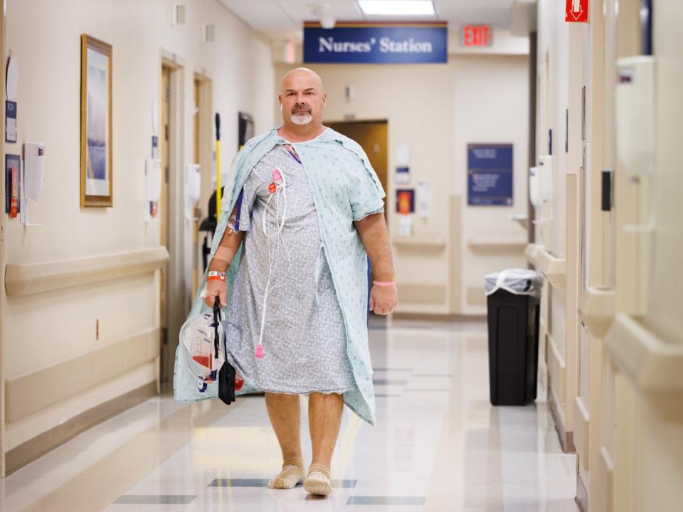 Herbert Davis, Madison-Ridgeland Academy football coach, walking the halls of the University of Mississippi Medical Center after undergoing surgery on Dec. 11 to receive a new kidney.