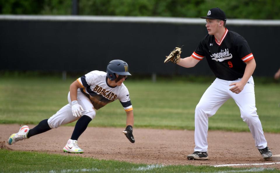 Logan Tammerine of Whiteford dives back into first base as Summerfield first baseman Brenden Myshock waits for the throw Friday.