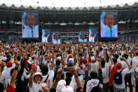 Supporters gesture as Indonesia's incumbent presidential candidate Joko Widodo speaks during a campaign rally at Gelora Bung Karno stadium in Jakarta, Indonesia, April 13, 2019. REUTERS/Willy Kurniawan