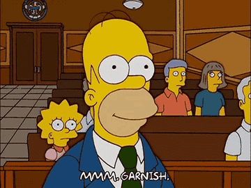 Homer Simpson in a courtroom, the text at the bottom says, "MMM, GARNISH."