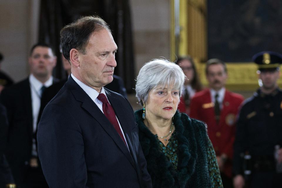 Supreme Court Justice Samuel Alito and his wife, Martha-Ann Alito, view the casket of the Rev. Billy Graham in the U.S. Capitol Rotunda in 2018. Two flags connected to the “Stop the Steal” movement were seen flying at homes owned by the Alitos, according to reports in The New York Times. After Democratic lawmakers called on the justice to recuse himself from cases involving the 2021 insurrection at the Capitol, he wrote: “My wife was solely responsible for having flagpoles put up at our residence and our vacation home and has flown a wide variety of flags over the years.”