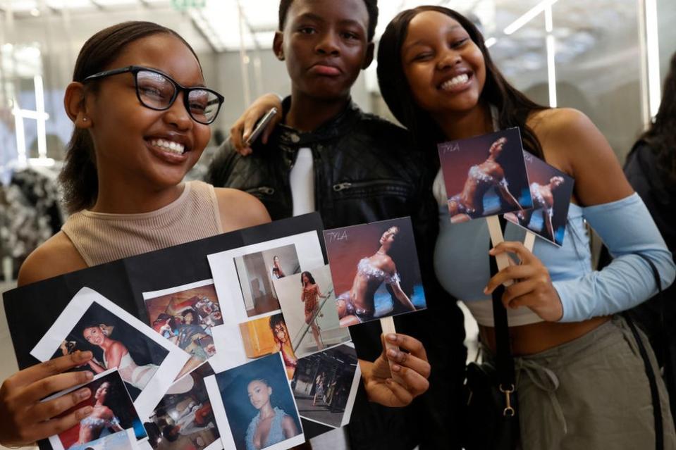 Fans of Tyla pose for a photograph.