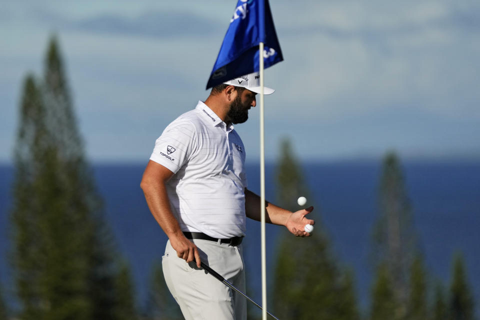 Jon Rahm, of Spain, flips his ball on the third green during the Tournament of Champions pro-am golf event, Wednesday, Jan. 4, 2023, at Kapalua Plantation Course in Kapalua, Hawaii. (AP Photo/Matt York)