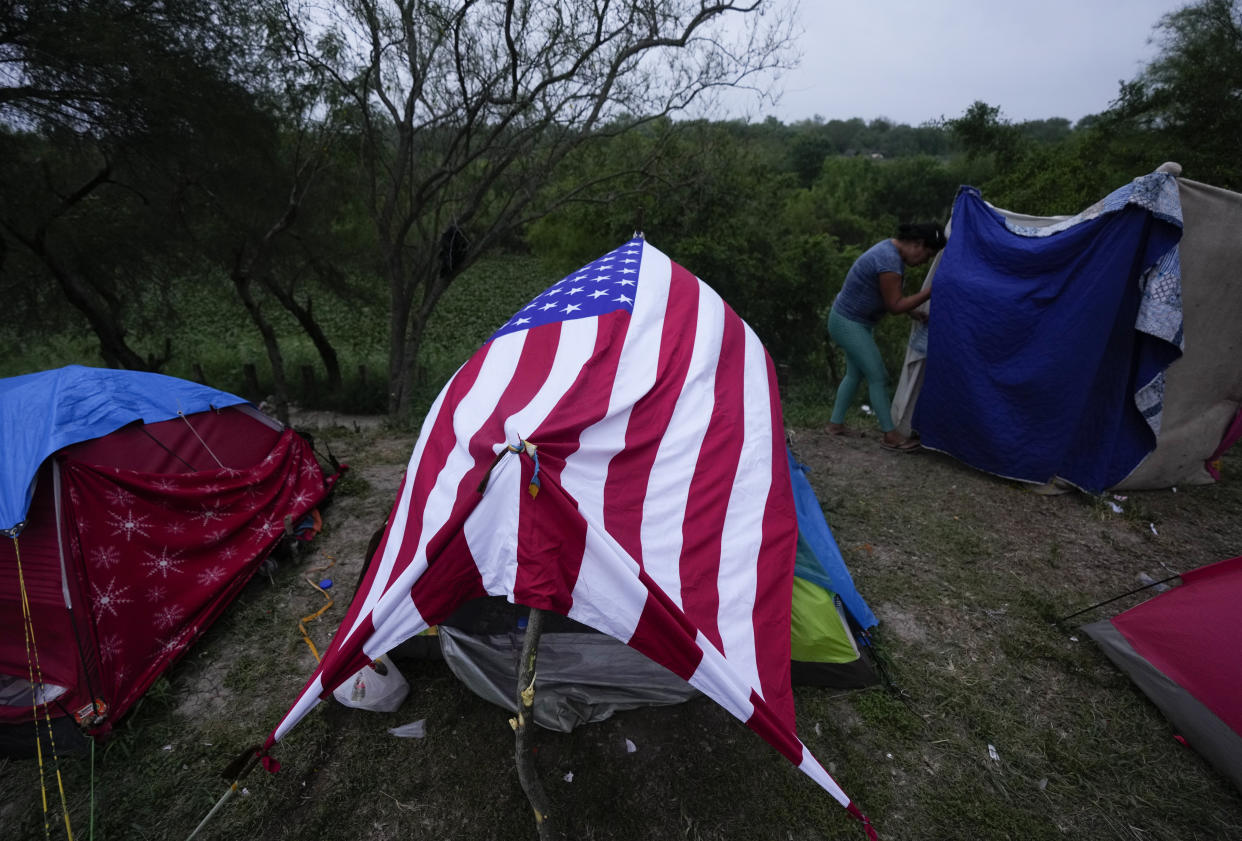 A Venezuelan migrant's makeshift tent is made from a U.S. flag, set up on a bank of the Rio Grande in Matamoros, Mexico, Friday, May 12, 2023, a day after pandemic-related asylum restrictions called Title 42 were lifted. (AP Photo/Fernando Llano)