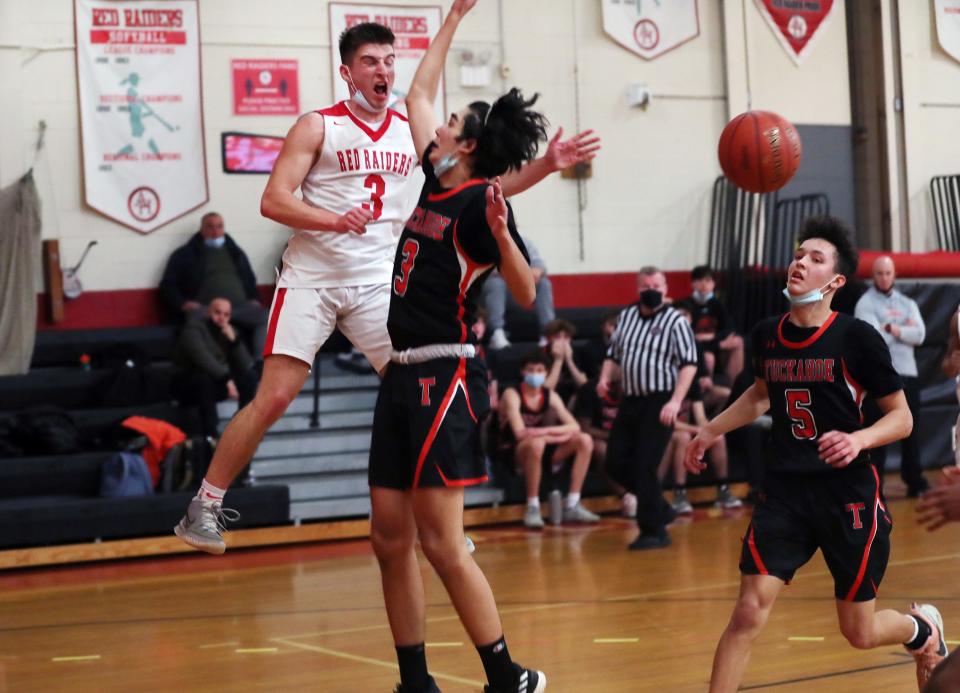 Hamilton's Chris Ward (3) passes to a teammate after finding his path to the basket blocked by Tuckahoe's Toma Ito-Chiahaia (3) during boys basketball playoff action at Alexander Hamilton High School in Elmsford Mar. 1, 2022.