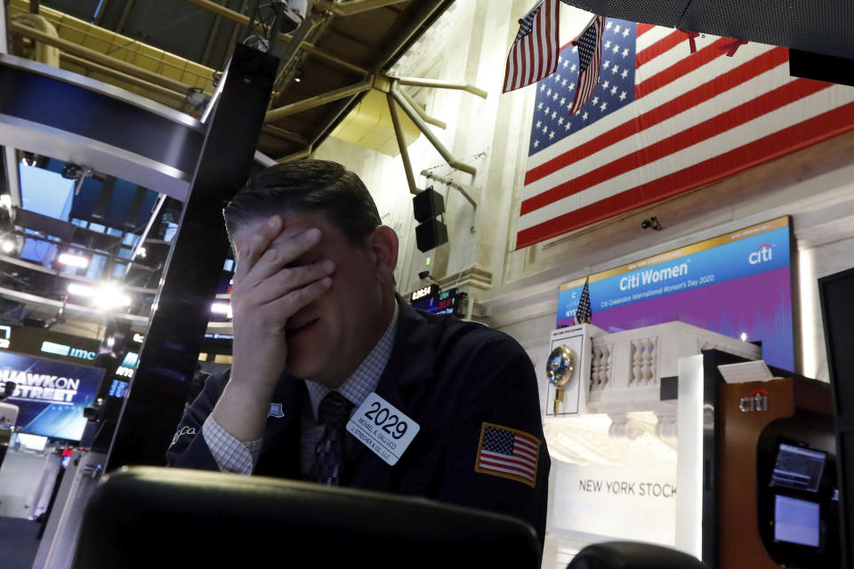 Trader Michael Gallucci prepares for the day's activity on the floor of the New York Stock Exchange, Monday, March 9, 2020. Trading in Wall Street futures has been halted after they fell by more than the daily limit of 5%. (AP Photo/Richard Drew)