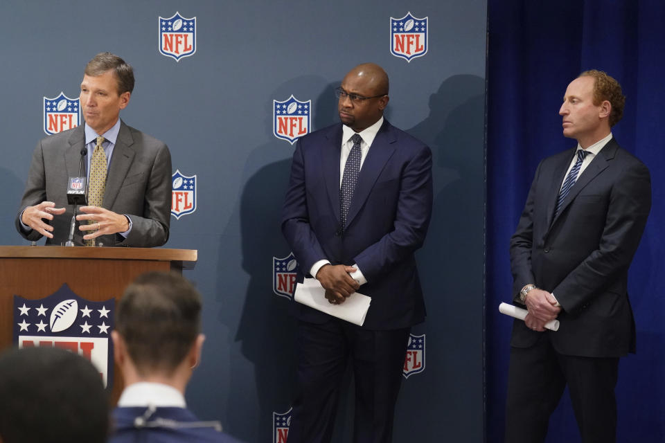 Allen Sills, Chief Medical Officer for the NFL, left, Troy Vincent, Executive Vice President of Football Operations at the NFL, center, and Jeff Miller, Executive Vice President of Communications at the NFL speak to reporters during the NFL football owners meeting in New York, Tuesday, Oct. 26, 2021. (AP Photo/Seth Wenig)