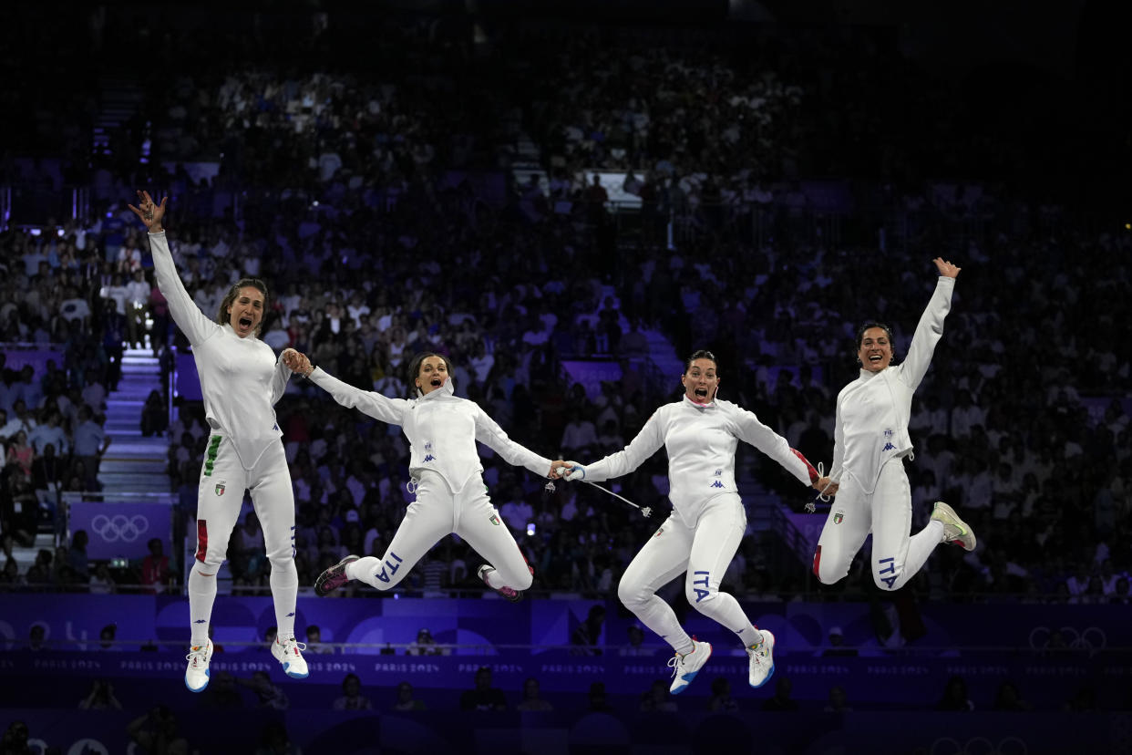 Italy's Alberta Santuccio, second right, celebrates with her teammates Rossella Fiamingo, second left, Giulia Rizzi, left, and Mara Navarria after winning the women's team Epee final match against France during the 2024 Summer Olympics at the Grand Palais on July 30, 2024, in Paris, France. (Andrew Medichini/AP)