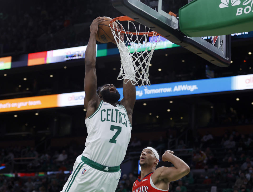 Boston Celtics guard Jaylen Brown (7) reacts after he is fouled by New Orleans Pelicans guard Josh Hart, right, during the second half of an NBA basketball game, Monday, Jan. 17, 2022, in Boston. (AP Photo/Mary Schwalm)