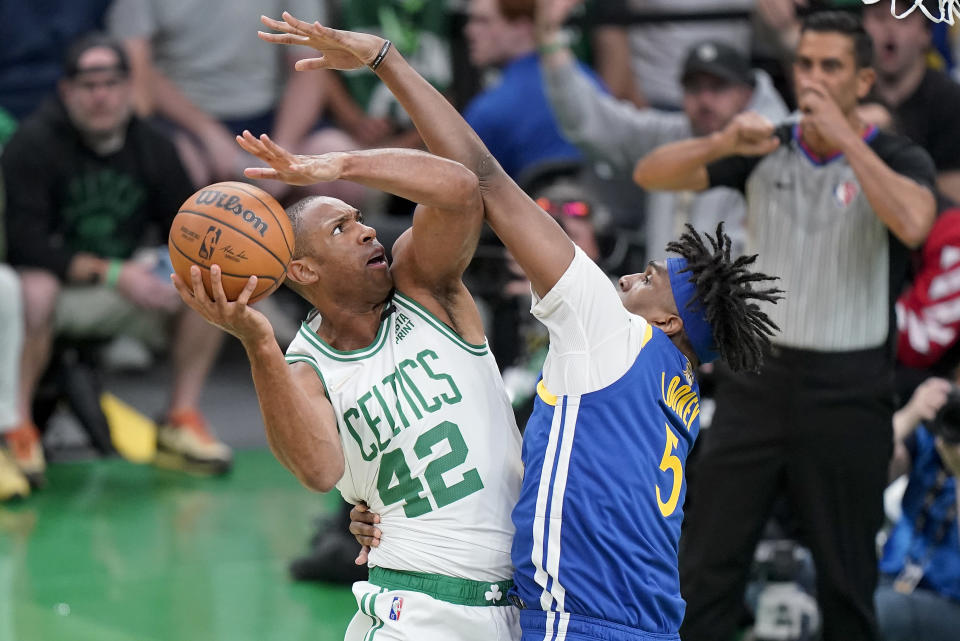 Boston Celtics center Al Horford (42) puts up a shot against Golden State Warriors center Kevon Looney (5) during the first quarter of Game 6 of basketball's NBA Finals, Thursday, June 16, 2022, in Boston. (AP Photo/Steven Senne)