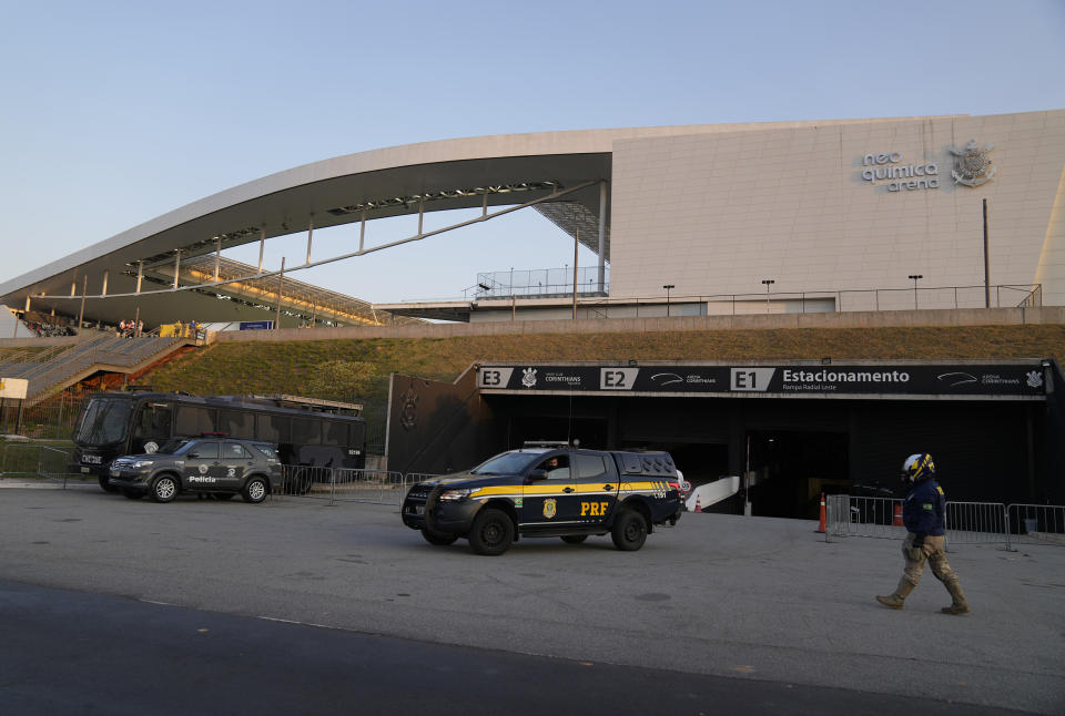 FILE - Police stand guard outside Neo Quimica Arena stadium after a qualifying soccer match between Argentina and Brazil for the FIFA World Cup Qatar 2022 was interrupted by health authorities in Sao Paulo, Brazil, Sept. 5, 2021. FIFA announced on Feb. 14, 2022 that it handed out fines and suspensions to players while ordering Argentina and Brazil to play the World Cup qualifier again that was abandoned when after Brazilian health officials stormed the field to question the quarantine status of Argentines. (AP Photo/Andre Penner, File)