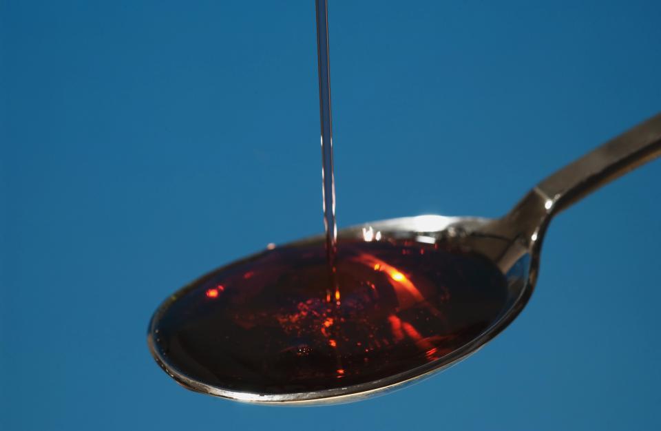 Cough syrup poured onto spoon, close-up (Photo by Universal Images Group via Getty Images)