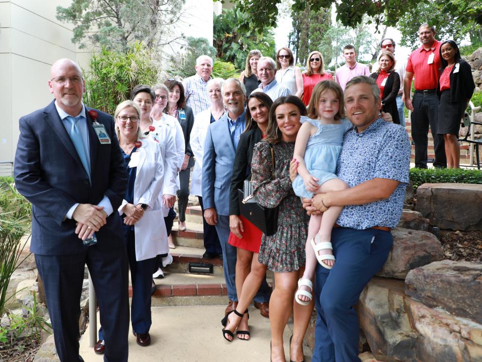 The Gray family --- Ryan, Kait and Palmer --- community members, and AdventHealth Ocala leaders recently gathered to commemorate a garden in the memory of McKenzie Kearney Gray.