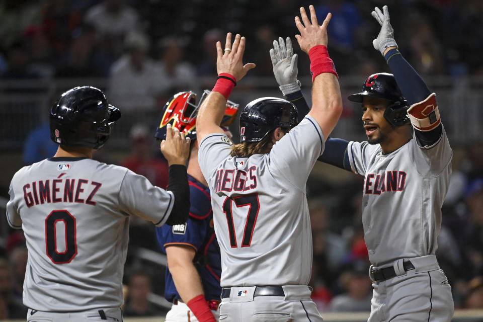 Cleveland Indians shortstop Andres Gimenez (0), catcher Austin Hedges (17) and left fielder Oscar Mercado (35) celebrate Mercado's three-run home run during the fifth inning of a baseball game against the Minnesota Twins, Wednesday, Sept. 15, 2021 in Minneapolis. (Aaron Lavinsky/Star Tribune via AP)