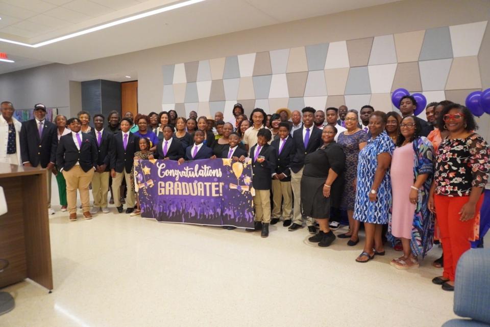 Participants of the Manhood Youth Development Foundation and families pose for a picture at the 13th Annual Manhood Celebration on Sunday in Gainesville.